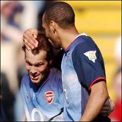 Ljungberg is embraced by team-mate Thierry Henry after putting Arsenal 1-0 up