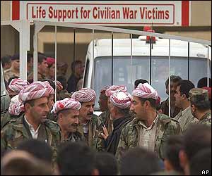 Kurdish fighters gather outside a hospital in the main Kurdish-controlled town of Irbil