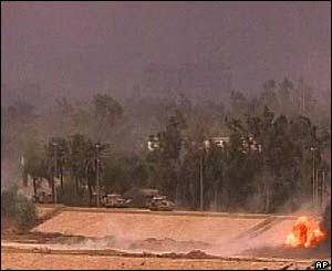 Tanks move along the river Tigris in Baghdad amid mortar explosions
