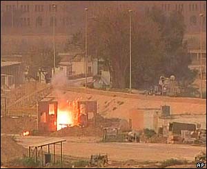 An American tank rolls past an explosion near the river Tigris