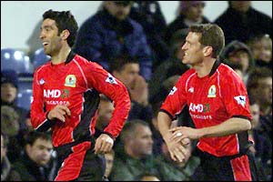 Hakan Sukur celebrates with team-mate Craig Short after hitting his first Blackburn goal against Fulham