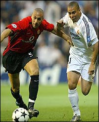 Real Madrid's Ronaldo challenges Manchester United's 