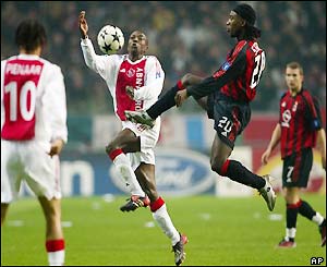 Ajax's Hatem Trabelsi (left) and AC Milan's Clarence Seedorf battle for the ball