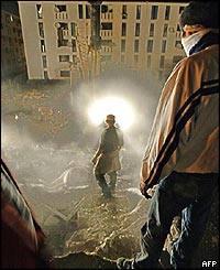 Youths search the debris of a 10-storey building in Reghaia