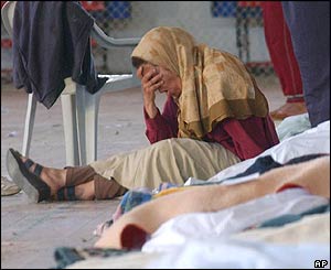Grieving relative at a gymnasium used as a morgue 