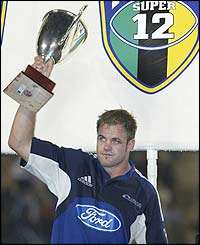 Auckland Blues captain Xavier Rush lifts the Super 12 trophy