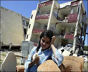 Girl finds chick in remains of apartment block