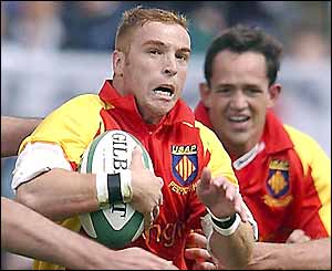 Perpignan's Pascal Bomati charges through a tackle