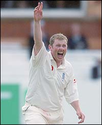 Anthony McGrath celebrates taking the wicket of Zimbabwe's Sean Irvine