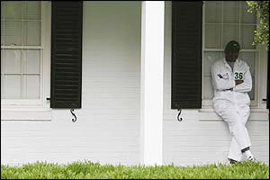 A caddie shelters from the rain