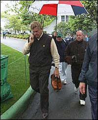 Scotland's Colin Montgomerie chats on the phone as he return sto the clubhouse