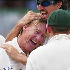 Andy Bichel is congratulated by his Australian team-mates after taking the wicket of Brian Lara