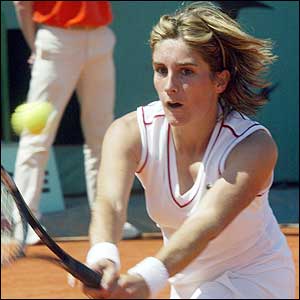 France's Emilie Loit plays a backhand volley