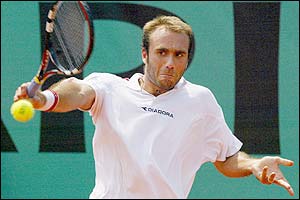 Peru's Luis Horna returns the ball to Roger Federer