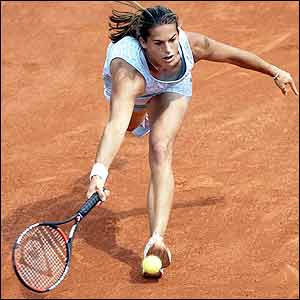 France's Amelie Mauresmo stretches for a forehand return
