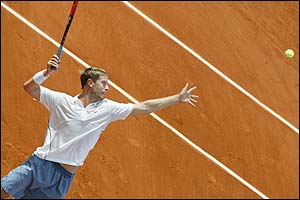 Russia's Yevgeny Kafelnikov serves on the way to victory against Julien Boutter