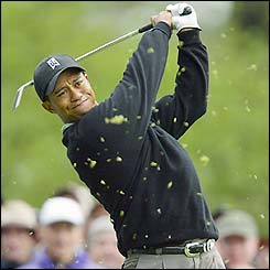 Tiger Woods drives at the fourth hole