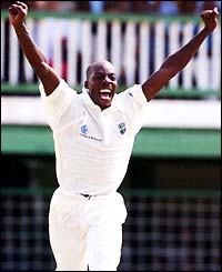 Vasbert Drakes celebrates taking an Australian wicket