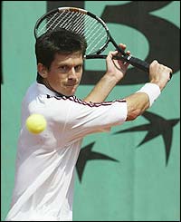 Tim Henman plays a backhand