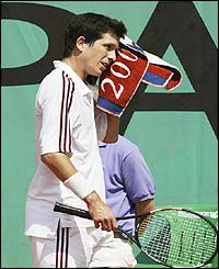 Tim Henman wipes himself with a towel