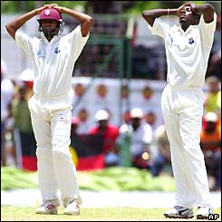 Darren Ganga and Pedro Collins of the West Indies stand with their hands on their heads in frustration after a catch is dropped