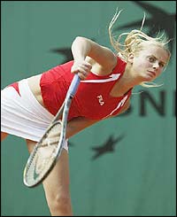 Jelena Dokic serves against Angelika Roesch