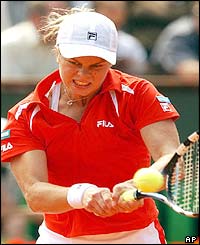 Kim Clijsters puts all her effort into a forehand return against Amy Frazier