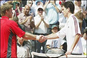Tim Henman shakes hands with Vladimir Voltchkov after beating him 6-2 6-3 6-1