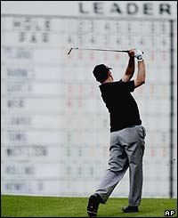 Canada's Mike Weir is framed by the leaderboard on the third hole 