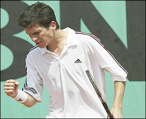 Tim Henman clenches his fist after winning a point