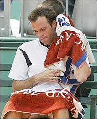 Britain's Greg Rusedski wipes himself with a towel