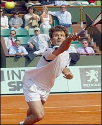 France's Fabrice Santoro returns a ball to Michael Chang