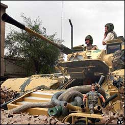 A toy action figure and mortar sits among the camouflage on a Desert Rats tank in central Basra, southern Iraq