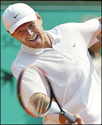 Russia's Yevgeny Kafelnikov hits a forehand