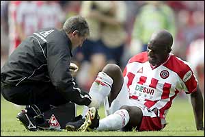 Wayne Allison receives treatment on his injury