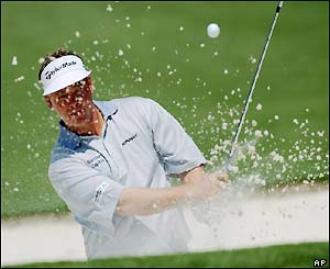 Darren Clarke gets stuck in a sand trap on the second hole and ends with a score of six over