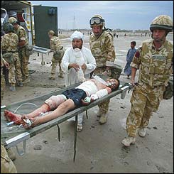 British soldiers take a wounded 13-year-old to a helicopter for evacuation