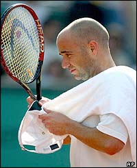 Andre Agassi wipes himself with a towel