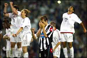 Antonio Conte holds his head as Milan's players celebrate