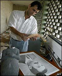 Museum employee with broken sculpture