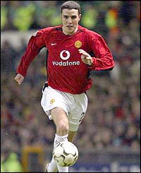 Manchester United's John O'Shea brings the ball forward