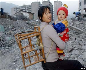 A family return to scavenge whatever they can from the ruins of their home in Fengjie
