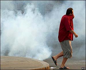 Man runs away from tear gas after riots in Geneva