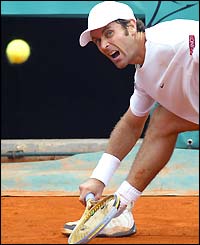 Felix Mantilla cries in anguish as he stretches but fails to reach a baseline ball