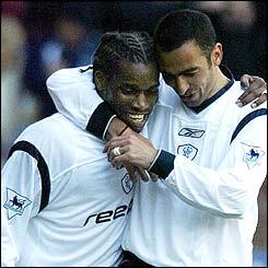 Jay-Jay Okocha and Youri Djorkaeff celebrate Okocha's goal 
