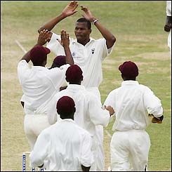 Windies bowler Merv Dillon celebrates the wicket of Justin Langer