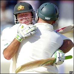 Lehmann and Ponting hug each other as Lehmann passes 150