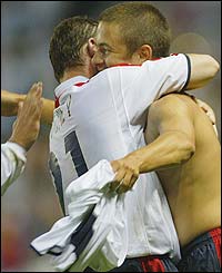Wayne Rooney embraces goalscorer Joe Cole