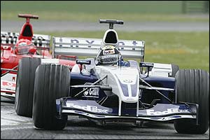 Ralf Schumacher takes the lead after beating brother Michael to the first corner 