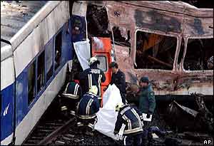 Rescuers take a body out of the wreckage, 4 June 2003
